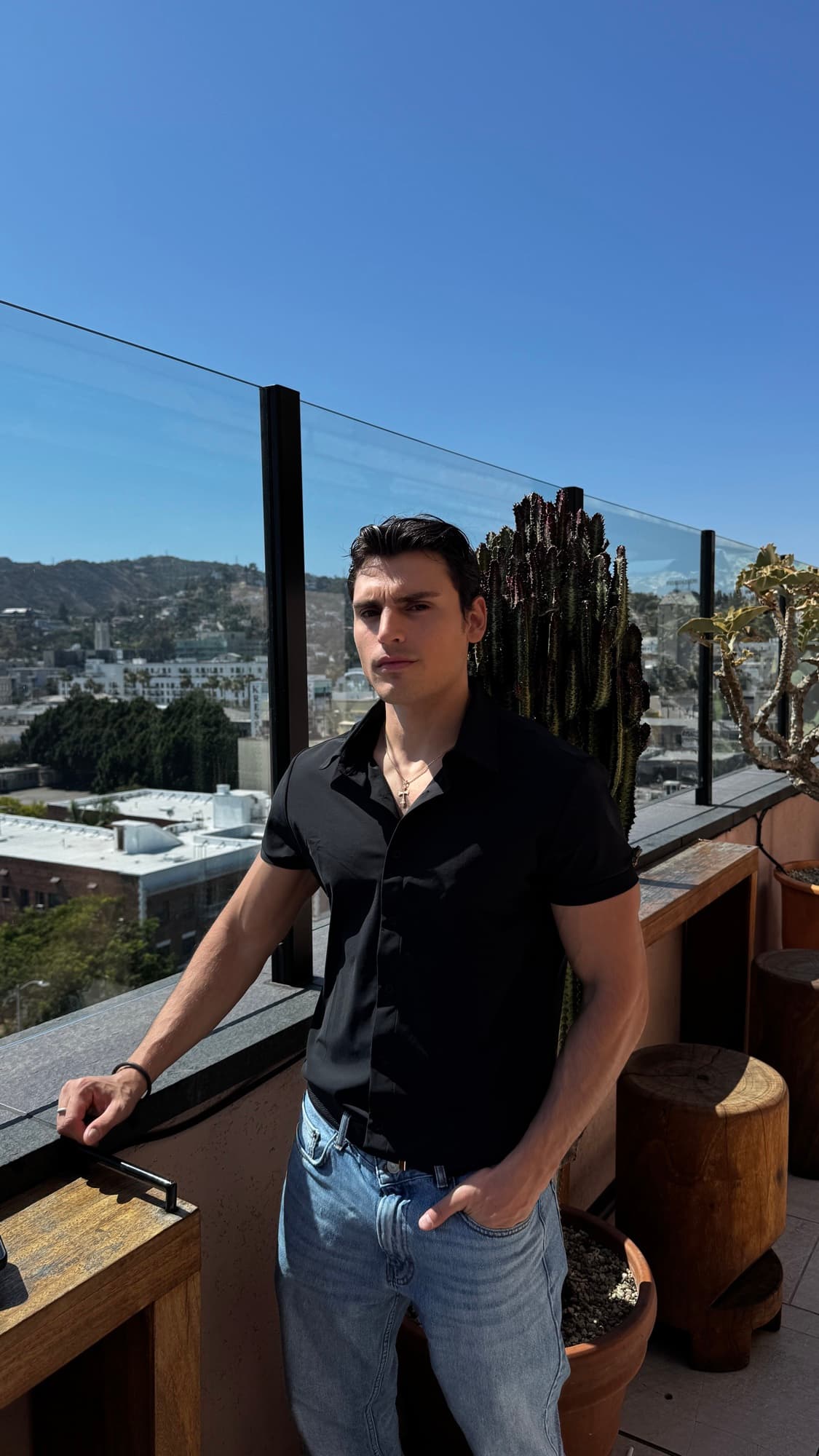 Eduard Martirosyan on a rooftop terrace overlooking the Hollywood Hills